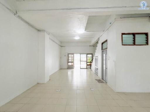 Spacious empty room with tiled floor and multiple windows