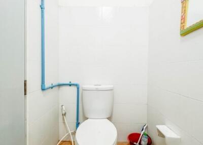 Bathroom with toilet and white walls