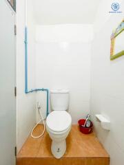 Bathroom with toilet and white walls