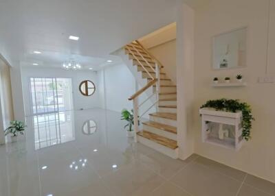 Modern living room with staircase and indoor plants