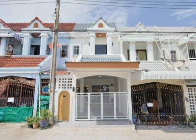 Front view of a townhouse with gated entrance