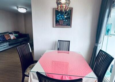 Dining area with table and chairs next to living room