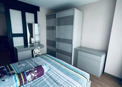 Modern bedroom with bed, nightstand, dresser, and wardrobe