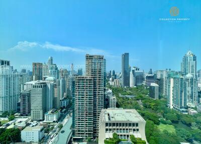 Cityscape view of multiple high-rise buildings with some greenery