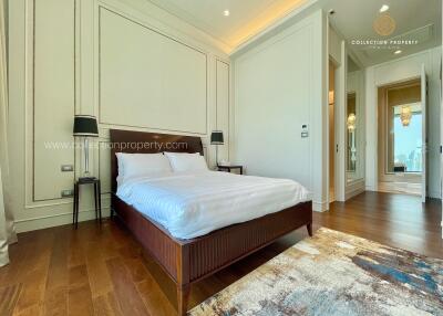 Spacious and modern bedroom with hardwood flooring and elegant decor