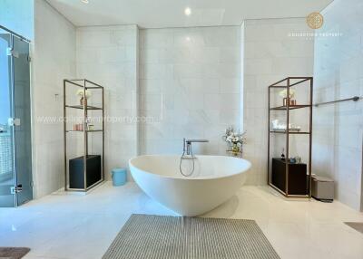 Modern bathroom with freestanding bathtub and shelves