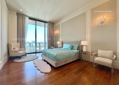 Spacious bedroom with a large window, city view, and modern decor.