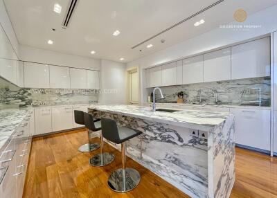 Modern kitchen with marble countertops and island
