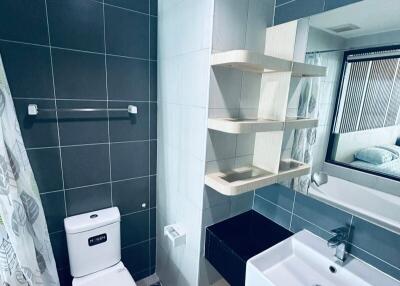 Modern bathroom with sink, toilet, mirror, and shower curtain