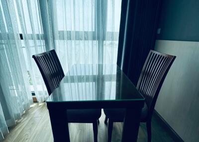 Dining area with table and two chairs by window