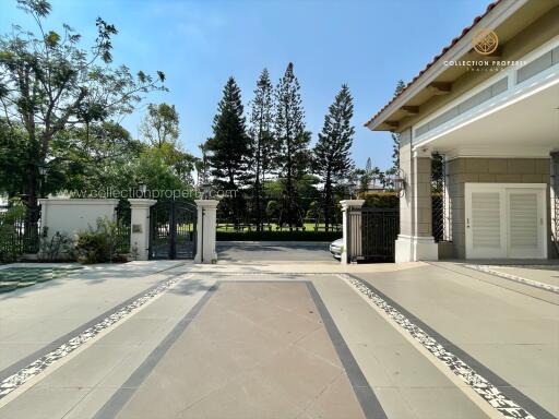 Exterior view of a property entrance with gate and driveway