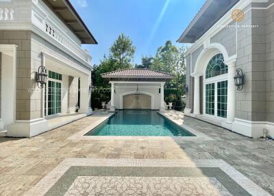 Outdoor view with a swimming pool flanked by two buildings