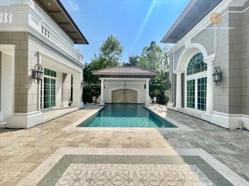 Outdoor view with a swimming pool flanked by two buildings