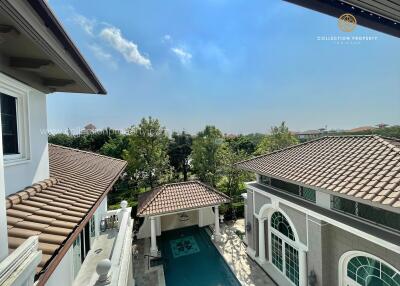 View of luxury property with swimming pool and greenery