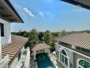 View of luxury property with swimming pool and greenery