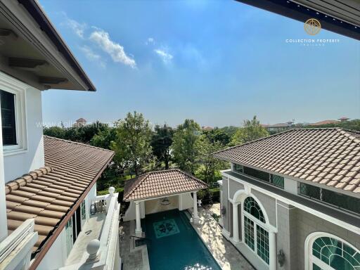 View of luxury property with swimming pool and greenery