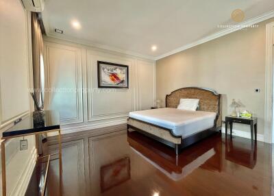 Spacious bedroom with wooden floors and modern decor