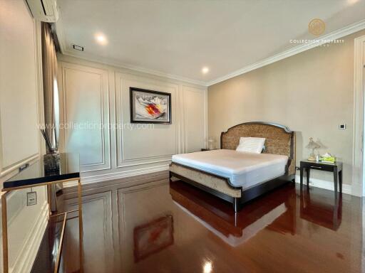 Spacious bedroom with wooden floors and modern decor