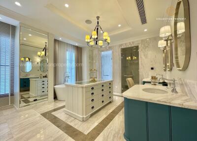 Luxury bathroom with a soaking tub, double vanities, and elegant lighting.