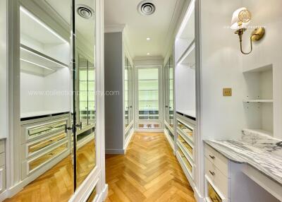 Spacious walk-in closet with ample storage and elegant lighting