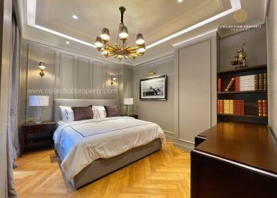 Elegant bedroom with chandelier and study area