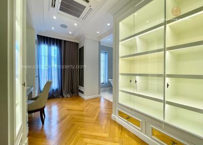 Spacious room with hardwood floors and built-in shelving
