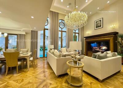 Spacious living room with elegant chandelier and wooden flooring