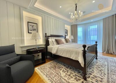 Spacious and elegant bedroom with a king-sized bed and seating area