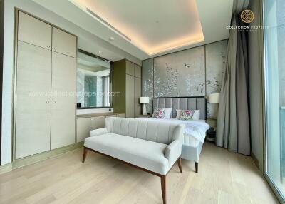 Modern bedroom with bed, wardrobe, bench, and large windows