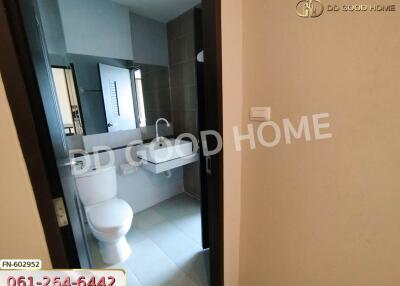 Bathroom view with sink, toilet, and mirror