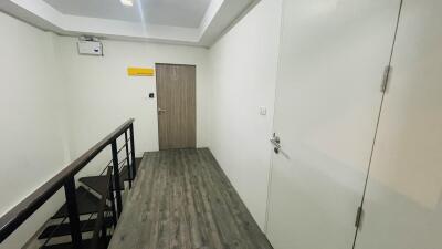 Modern hallway with wooden flooring and doors