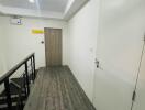 Modern hallway with wooden flooring and doors