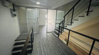 Modern industrial staircase and glass-walled room