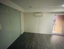 Empty room with air conditioner and balcony door