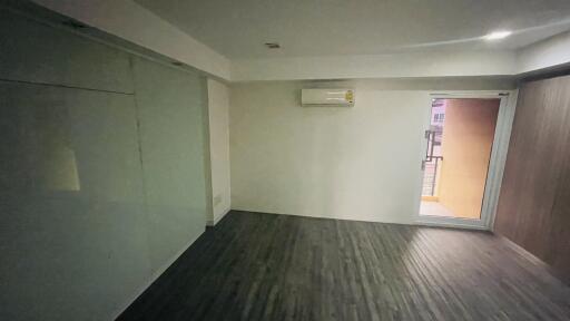 Empty room with air conditioner and balcony door