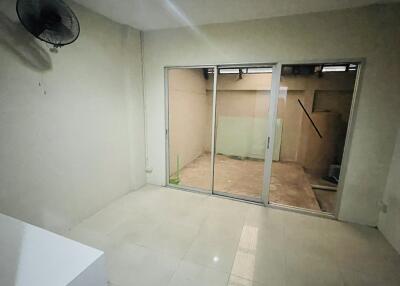 Empty room with a glass sliding door leading to a patio