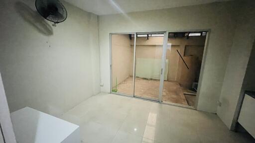 Empty room with a glass sliding door leading to a patio