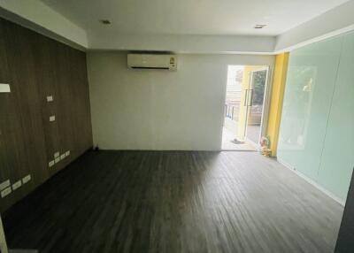 Spacious living room with air conditioning and access to balcony