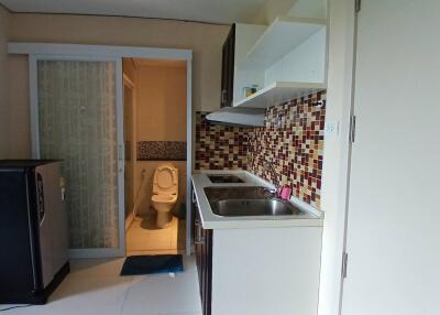 Small kitchen with a view into the bathroom