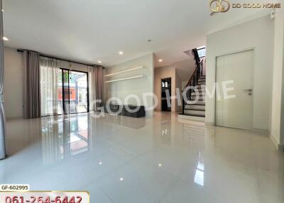 Spacious living room with large windows and shiny floor tiles