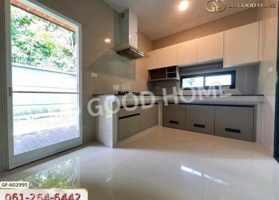 Modern kitchen with built-in cabinets, stove, and range hood