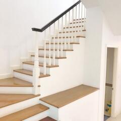 Elegant wooden staircase with white railing