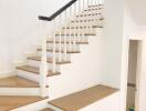 Elegant wooden staircase with white railing