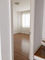 Empty bedroom with wooden floor and large window