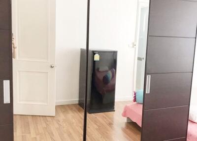 Bedroom with mirror wardrobe and wooden floor