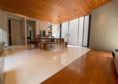 spacious modern living room with wooden ceiling and floor