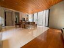 spacious modern living room with wooden ceiling and floor