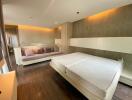 Modern bedroom with wooden flooring, double bed, and sofa