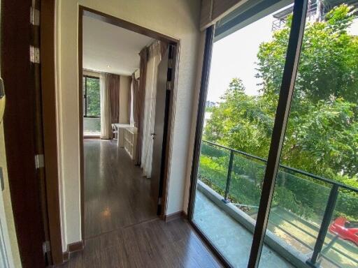 Bright living area with large windows and a view of greenery