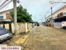 Residential neighborhood with houses and cars parked outside